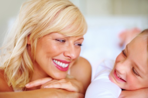 Closeup portrait of a smiling mother and daughter looking at each other