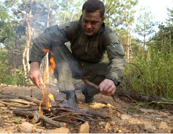 Maj. Paul Neidhardt starts a fire using a block of flint during combat search and rescue training Sept. 21 near Osan Air Base, South Korea. Annual training is conducted by survival, evasion, resistance and escape instructors to reacquaint aircrew members with combat search and rescue procedures and techniques. Major Neidhardt is with the 25th Fighter Squadron at Osan AB. (U.S. Air Force photo/Airman 1st Class Chad Strohmeyer)
