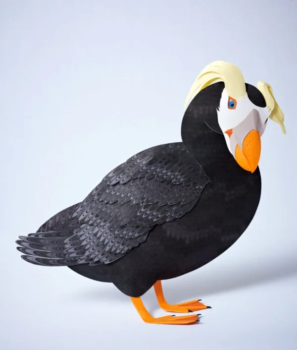 A 3D paper cut image of a tufted puffin for Seattle Aquarium by papaer sculptor Gail Armstrong