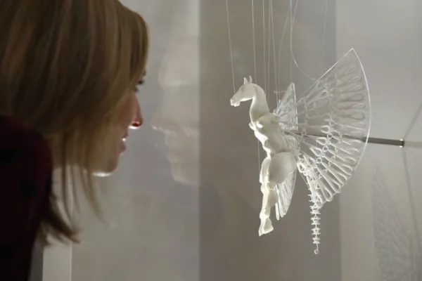 LONDON, ENGLAND - OCTOBER 08:  A woman admires a 3D printed artwork which is displayed in the exhibition '3D: printing the future' in the Science Museum on October 8, 2013 in London, England. The exhibition, which opens to the public tomorrow, features over 600 3D printed objects ranging from: replacement organs, artworks, aircraft parts and a handgun.   (Photo by Oli Scarff/Getty Images)